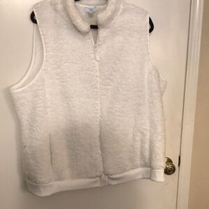 This jacket is white faux fur sleeveless with a front zipper.